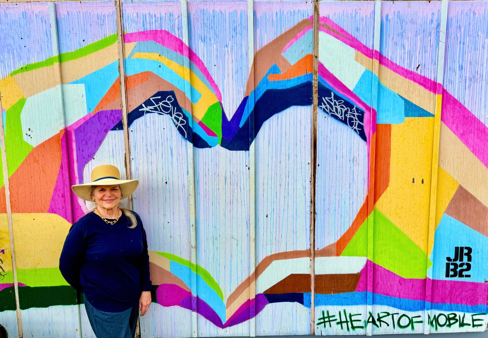 Nina in front of a mural art
